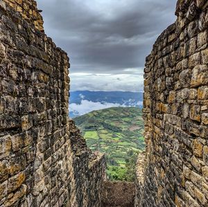 View of stone wall against cloudy sky