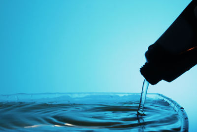 Close-up of blue water bottle against white background