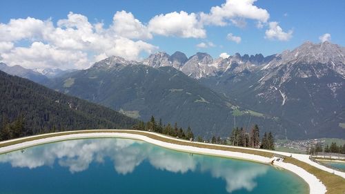 Panoramic view of road by mountains against sky