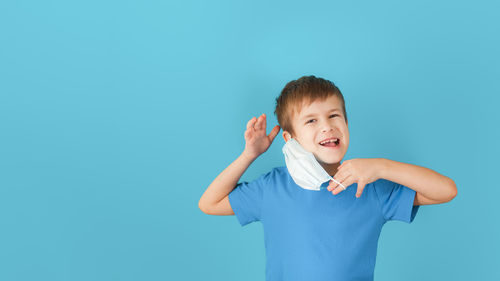 Portrait of smiling boy against blue background