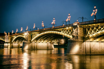 Illuminated margaret bridge over river against sky at dusk