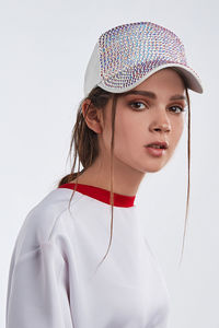 Portrait of young woman against white background