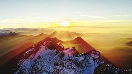 Scenic view of mountains against sky during sunrise