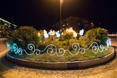 Illuminated lighting equipment on street in park at night