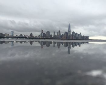 City skyline against cloudy sky