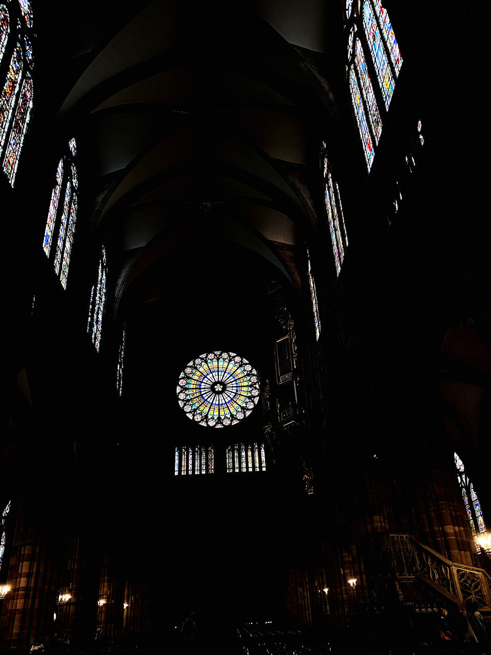 architecture, built structure, darkness, night, light, low angle view, indoors, building, place of worship, belief, religion, no people, spirituality, arch, illuminated, ceiling, travel destinations, stained glass, window, catholicism, glass