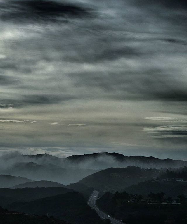 mountain, sky, scenics, cloud - sky, beauty in nature, water, weather, nature, tranquil scene, cloudy, tranquility, sea, mountain range, landscape, dusk, idyllic, sunset, outdoors, overcast, no people