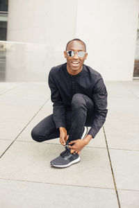 Portrait of man tying shoelaces