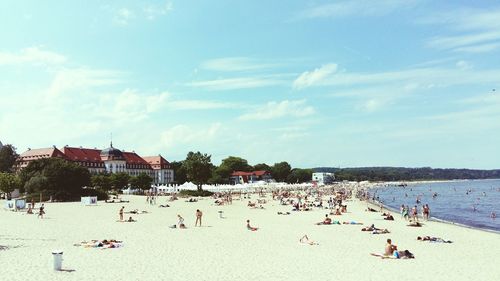 People at beach against sky