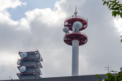 Low angle view of communications tower against sky