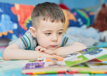 Close-up of cute girl drawing on table