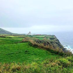 Scenic view of land and sea against sky