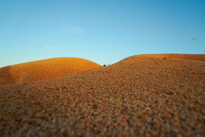 Surface level of desert against sky