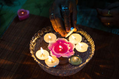 High angle view of hand holding tea light