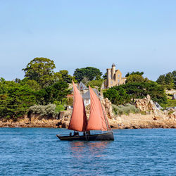 Sailboat on sea against sky