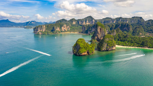 Scenic view of sea and mountains against sky