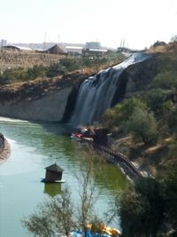 Scenic view of waterfall against sky