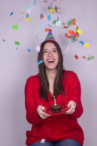 Portrait of smiling young woman wearing mask