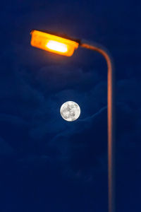 Low angle view of illuminated moon in sky