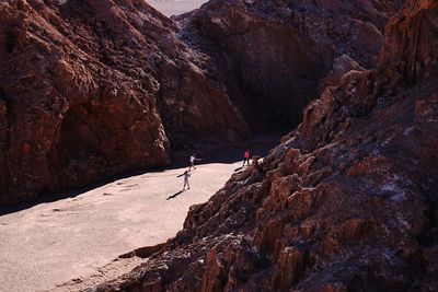 People walking amidst rock formations