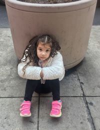 Portrait of smiling girl on footpath