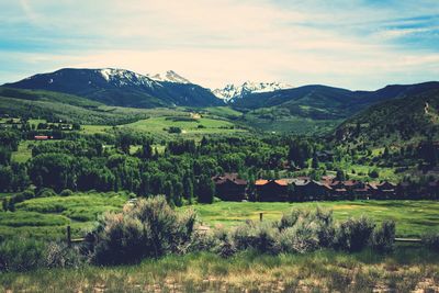 Scenic view of trees and mountains against sky