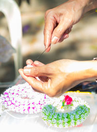 Midsection of woman holding flowers
