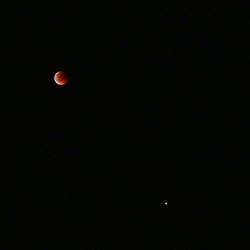 Low angle view of moon against sky at night