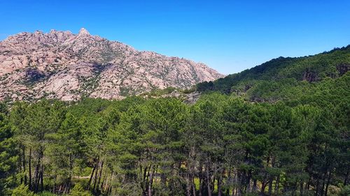 Scenic view of mountains against clear blue sky