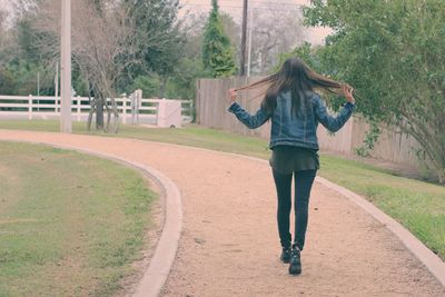 Rear view of woman walking in park