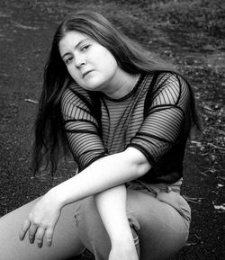 Portrait of beautiful woman sitting outdoors