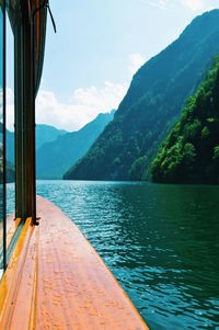 Scenic view of lake by mountains against sky