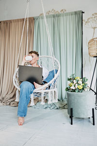 Hipster woman blogger working with laptop in studio. modern girl creator with laptop