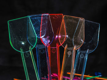 Close-up of illuminated lighting equipment against black background