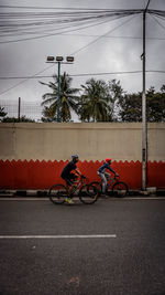 Bicycle on road against sky in city