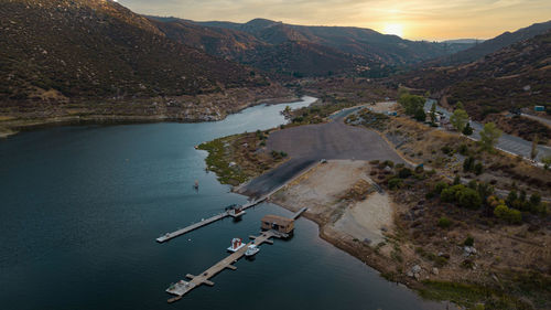 High angle view of river amidst mountains against sky