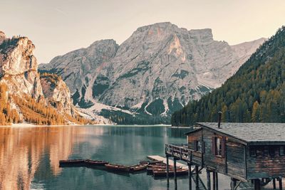 Scenic view of lake by mountains against sky. boathouse at a lake.