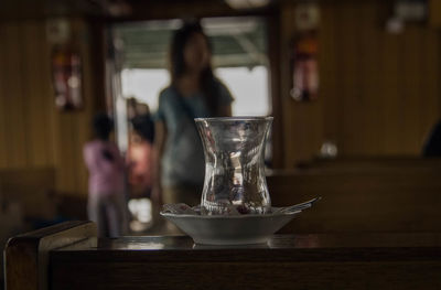 Turkish tea glass on wooden table at cafe