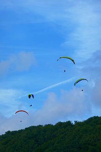 People flying kite against sky