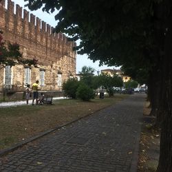 People on street amidst buildings in city