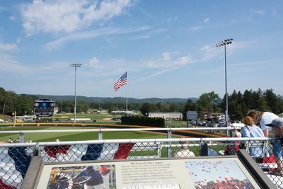 People relaxing in flag against sky