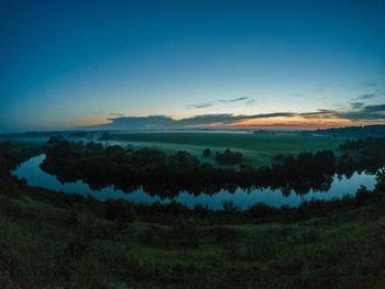 Scenic view of land against sky during sunset