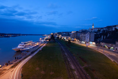 Panoramic view of city by sea against blue sky