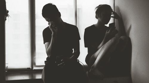 Men standing by window