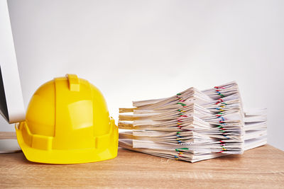 Stack of yellow and table against white background