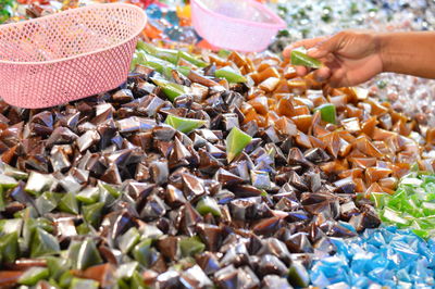 Midsection of woman in basket at market stall