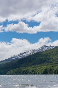 Scenic view of lake and mountains against sky