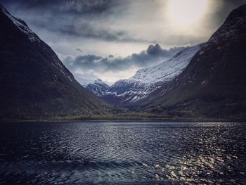 Scenic view of lake against cloudy sky
