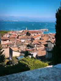 High angle view of townscape by sea against sky