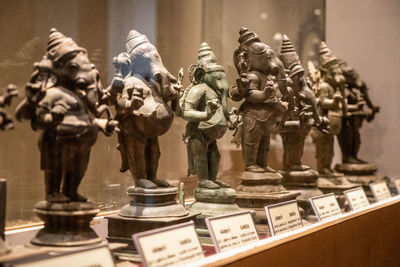 Close-up of statues on table in museum